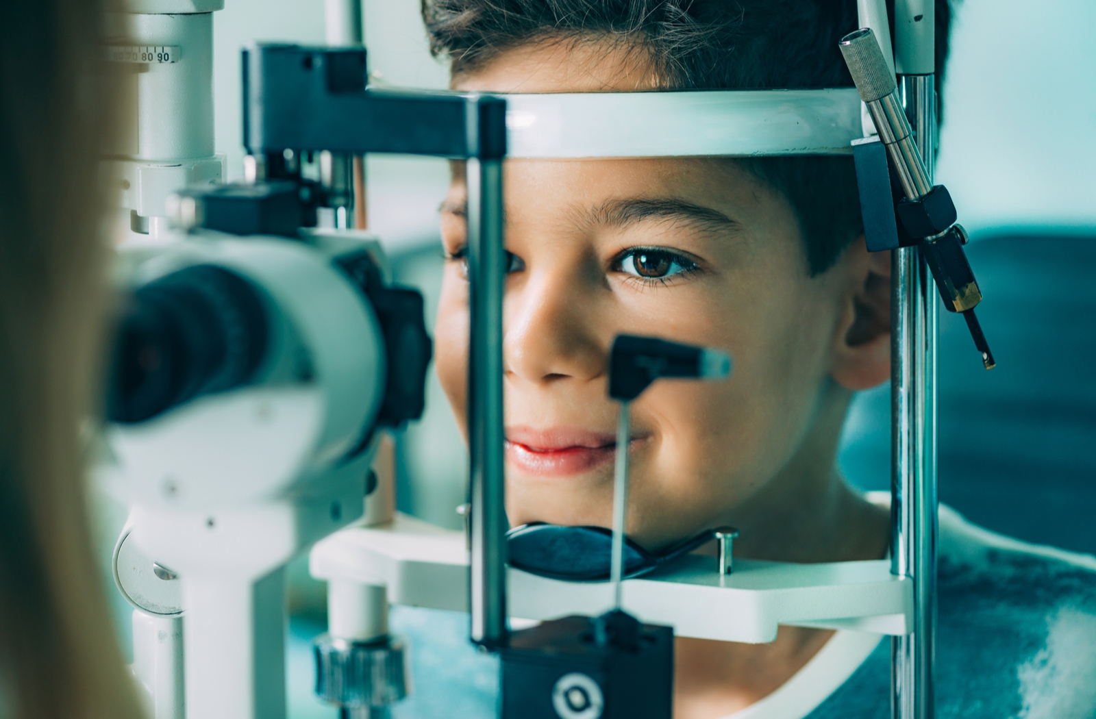 A boy at the optometrists receiving an eye exam