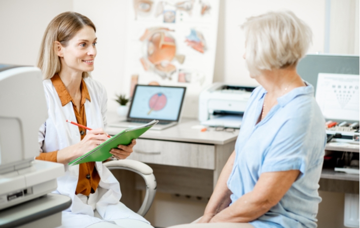 A woman discussing her visual field test results with her optometrist