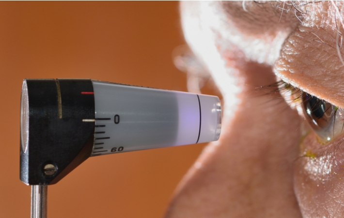 A close up of a senior undergoing a tonometry test to test eye pressure