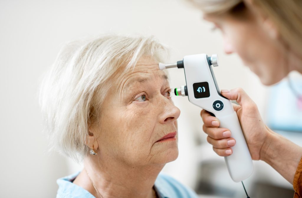 A senior woman at her optometrist getting her eye pressure tested