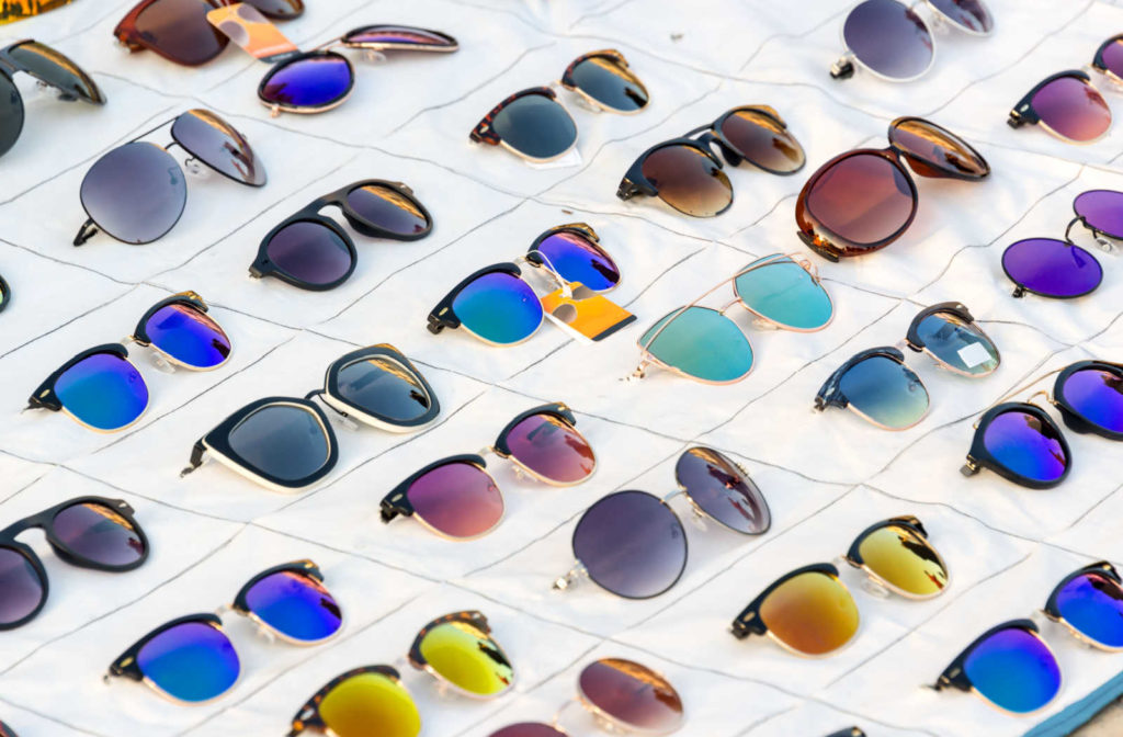 A variety of UV protection sunglass styles laying out on a surface